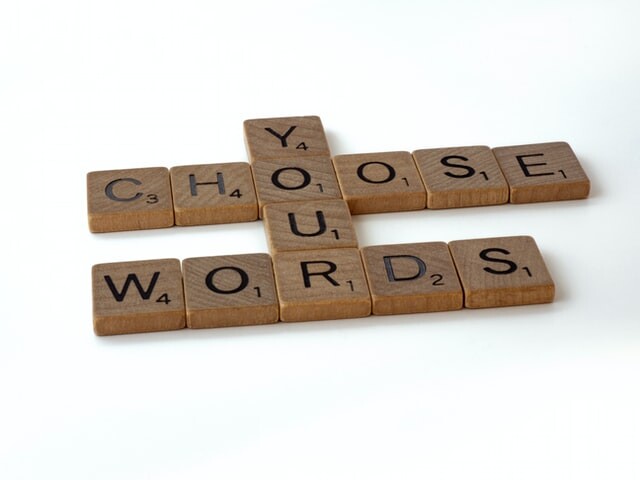 Wooden scrabble tiles which spell out: choose your words