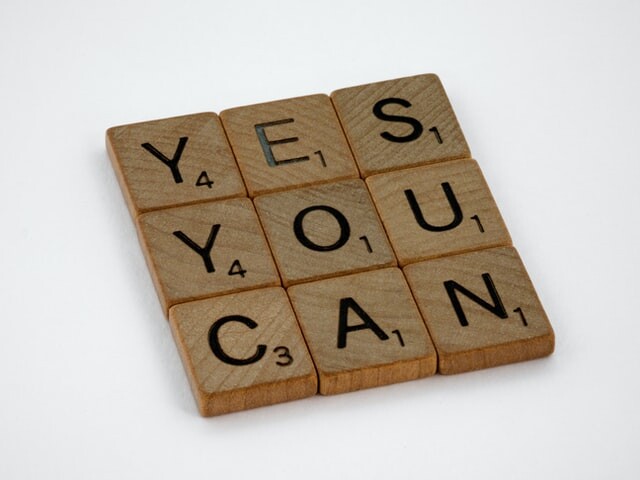 Wooden scrabble tiles which spell out: Yes you can
